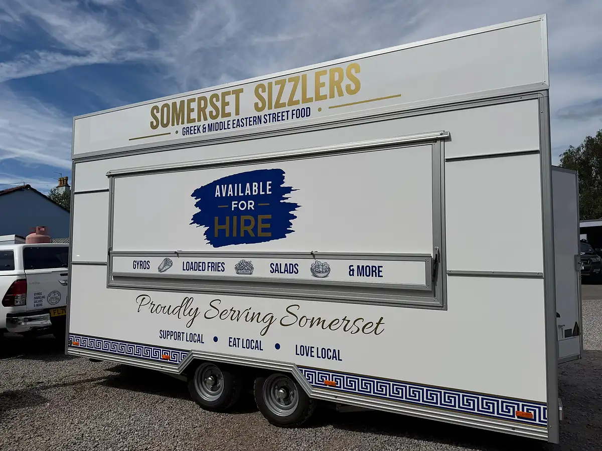 Side view of the trailer showing the Somerset Sizzlers livery and menu board
