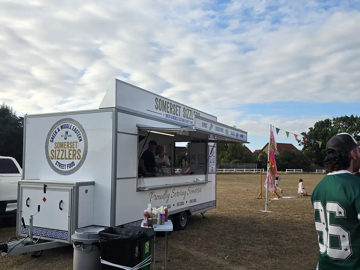 Serving customers at a village event with bunting in the background