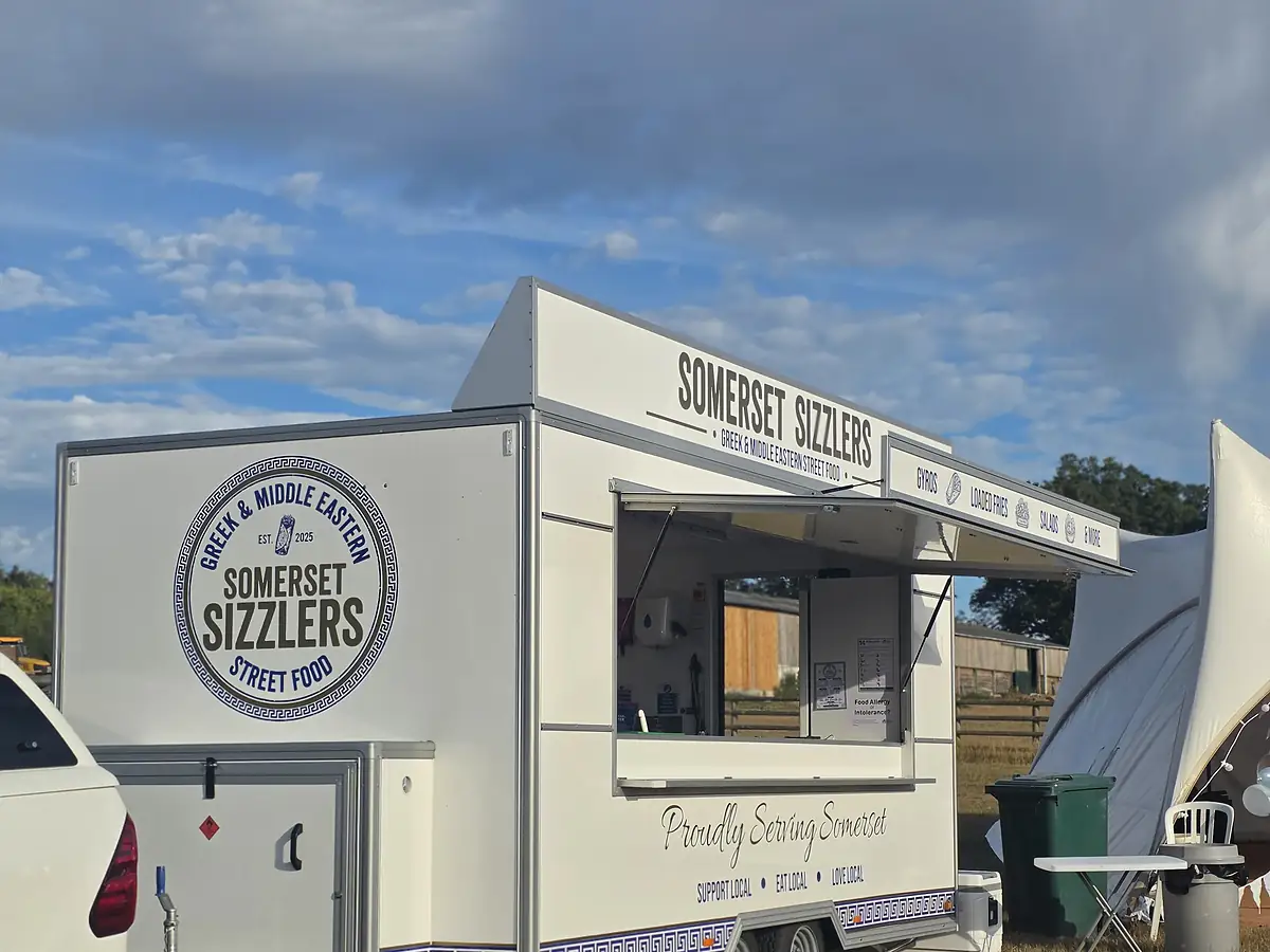 The trailer set up in a field in the early evening light