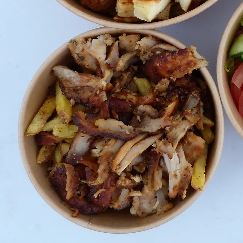 Loaded fries — a box of fries piled high with chicken gyros, seen from above