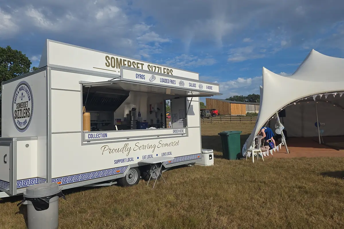 The Somerset Sizzlers trailer set up beside a white stretch marquee at a private celebration